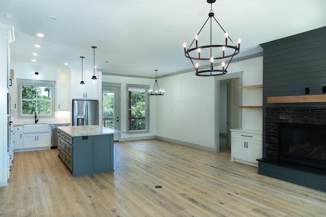 100 Laurie Dr, Mena, AR 71953 - kitchen featuring white cabinets, a notable chandelier, and stainless steel fridge with ice dispenser