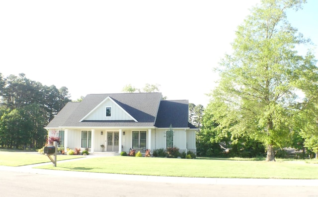 100 Laurie Dr, Mena, AR 71953 - modern inspired farmhouse with a porch, a front lawn, and board and batten siding