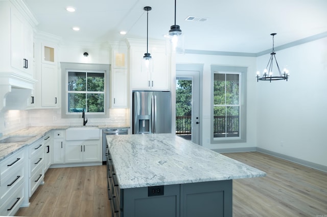100 Laurie Dr, Mena, AR 71953 - kitchen featuring a sink, appliances with stainless steel finishes, plenty of natural light, and light wood-style flooring