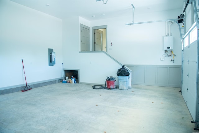 100 Laurie Dr, Mena, AR 71953 - garage featuring wainscoting, a decorative wall, electric panel, and tankless water heater