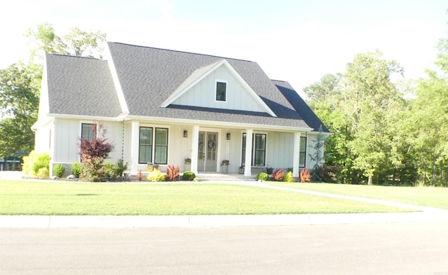 100 Laurie Dr, Mena, AR 71953 - modern inspired farmhouse with a front lawn, roof with shingles, covered porch, and board and batten siding