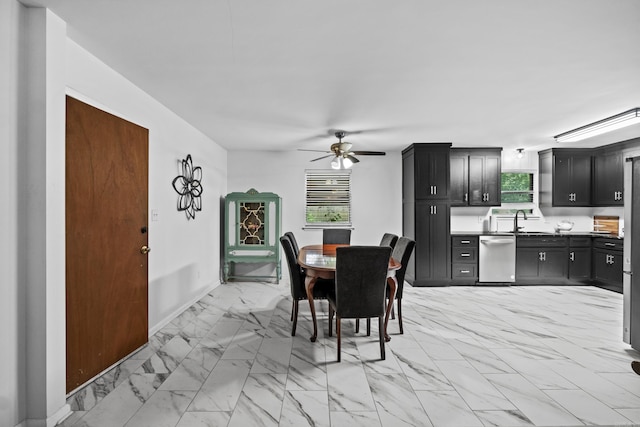 dining area with baseboards, ceiling fan, and marble finish floor
