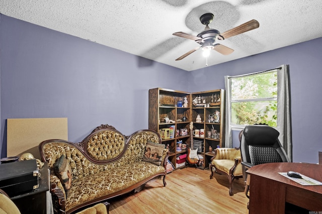 office area featuring a textured ceiling, ceiling fan, and wood finished floors