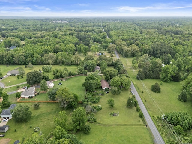 birds eye view of property featuring a view of trees
