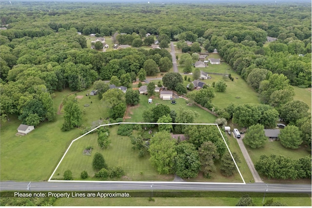 bird's eye view featuring a wooded view