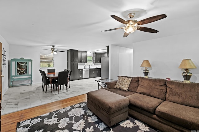 living room featuring ceiling fan and light wood-type flooring