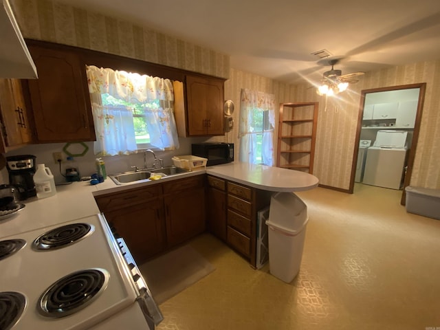 113 E Simpson St, Mount Ida, AR 71957 - kitchen with a ceiling fan, black microwave, a sink, a peninsula, and wallpapered walls