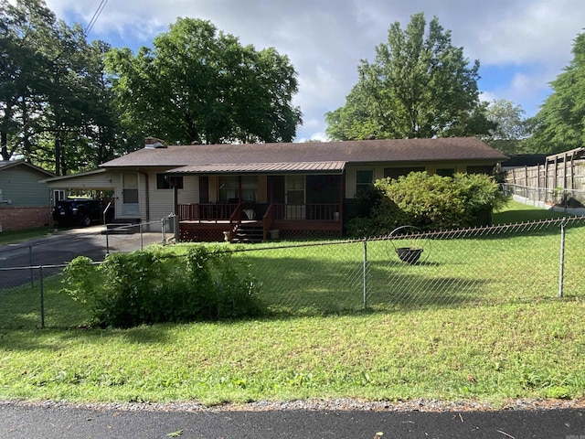 113 E Simpson St, Mount Ida, AR 71957 - ranch-style home with aphalt driveway, a carport, a front yard, covered porch, and fence private yard