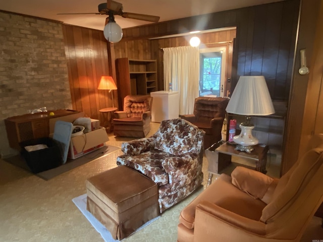 113 E Simpson St, Mount Ida, AR 71957 - sitting room featuring a ceiling fan, carpet, brick wall, and wooden walls