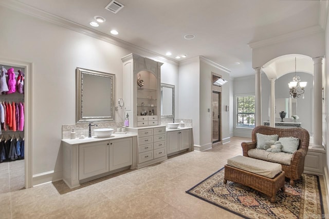10 Lakewood Park Dr, North Little Rock, AR 72116 - full bath featuring crown molding, a sink, decorative columns, two vanities, and visible vents