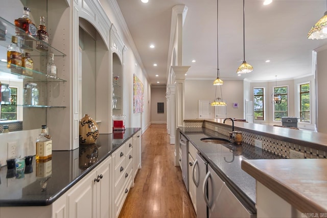 10 Lakewood Park Dr, North Little Rock, AR 72116 - bar with pendant lighting, ornamental molding, light wood-style floors, recessed lighting, and a sink