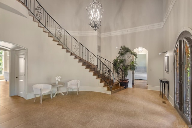 10 Lakewood Park Dr, North Little Rock, AR 72116 - tiled entryway with stairway, arched walkways, a high ceiling, and baseboards