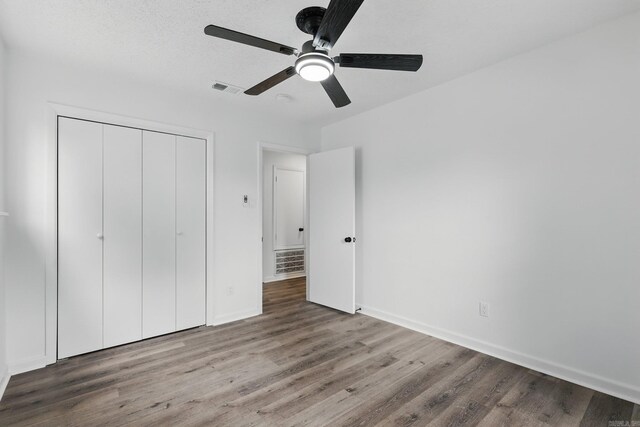 300 Dryad Ln, Little Rock, AR 72205 - unfurnished bedroom featuring visible vents, baseboards, wood finished floors, and a closet