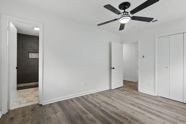 300 Dryad Ln, Little Rock, AR 72205 - unfurnished bedroom featuring visible vents, a closet, wood finished floors, baseboards, and ensuite bathroom