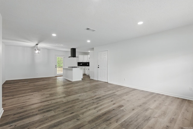 300 Dryad Ln, Little Rock, AR 72205 - unfurnished living room featuring baseboards, recessed lighting, wood finished floors, and visible vents