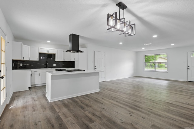 300 Dryad Ln, Little Rock, AR 72205 - kitchen with gas cooktop, wood finished floors, island range hood, and tasteful backsplash