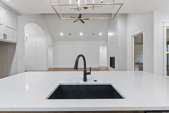 2940 Orchard View Dr, Conway, AR 72034 - kitchen with a sink, light stone counters, a ceiling fan, and open floor plan