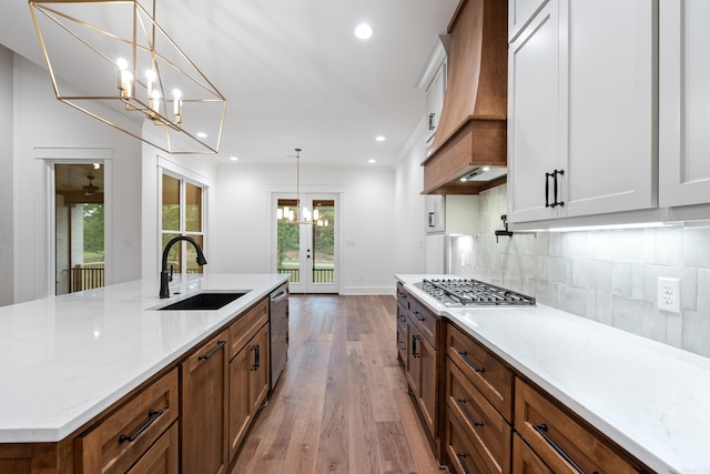 2940 Orchard View Dr, Conway, AR 72034 - kitchen featuring dark wood-style flooring, tasteful backsplash, a sink, custom exhaust hood, and stainless steel appliances