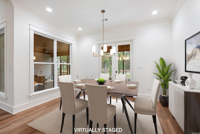 2940 Orchard View Dr, Conway, AR 72034 - dining area with a notable chandelier, ornamental molding, visible vents, and light wood-type flooring