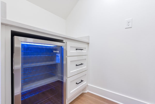 2940 Orchard View Dr, Conway, AR 72034 - interior details featuring wine cooler, baseboards, and wood finished floors