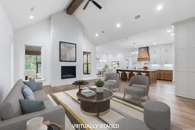 2940 Orchard View Dr, Conway, AR 72034 - living area featuring beam ceiling, high vaulted ceiling, a large fireplace, light wood-style flooring, and recessed lighting