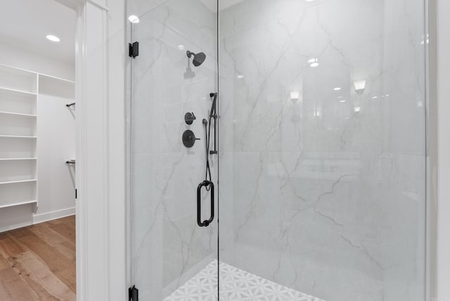 2940 Orchard View Dr, Conway, AR 72034 - full bathroom featuring recessed lighting, a marble finish shower, a walk in closet, and wood finished floors