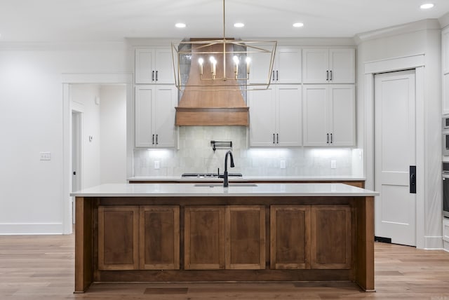 2940 Orchard View Dr, Conway, AR 72034 - kitchen featuring light countertops, a sink, light wood finished floors, and tasteful backsplash