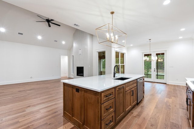 2940 Orchard View Dr, Conway, AR 72034 - kitchen featuring stainless steel dishwasher, brown cabinetry, visible vents, a center island with sink, and a sink