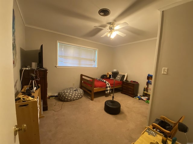 carpeted bedroom featuring ornamental molding and a ceiling fan