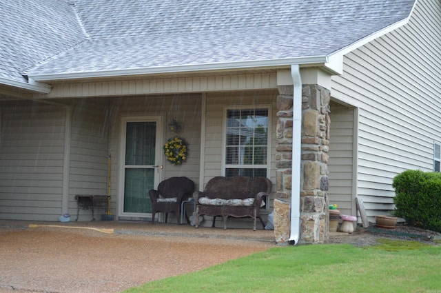 doorway to property with roof with shingles and stone siding