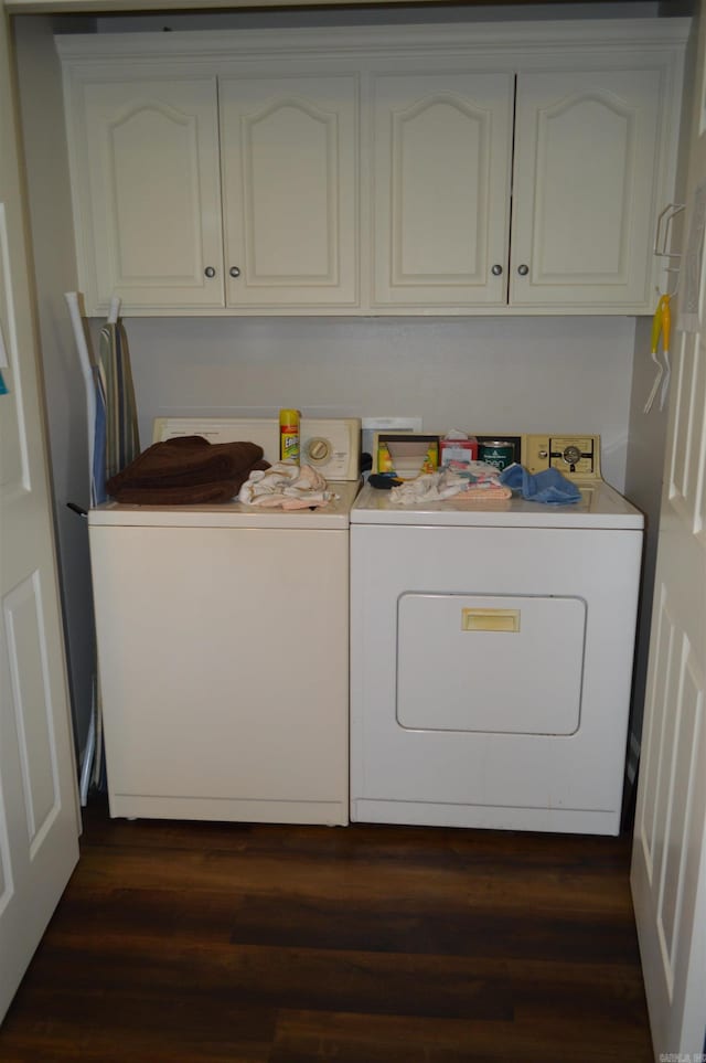 laundry area with washer and clothes dryer, cabinet space, and dark wood-type flooring