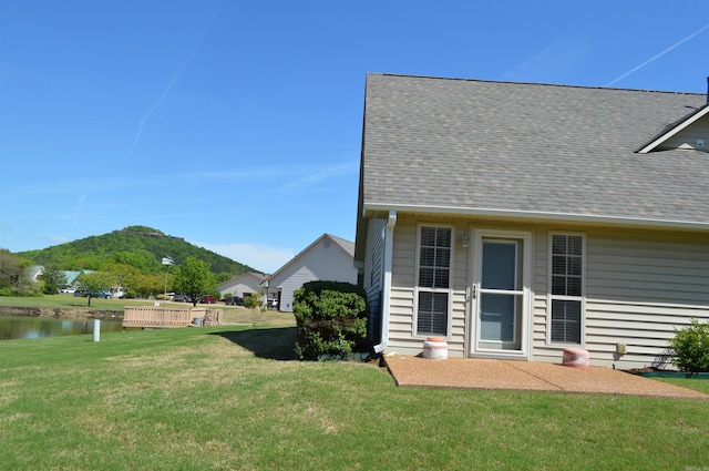 exterior space with a water and mountain view