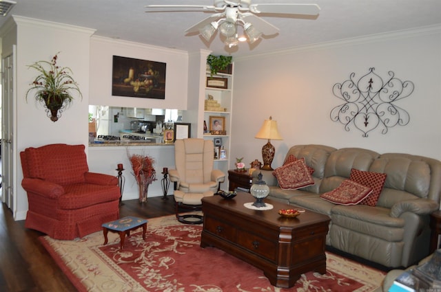living room with crown molding, a ceiling fan, wood finished floors, and visible vents
