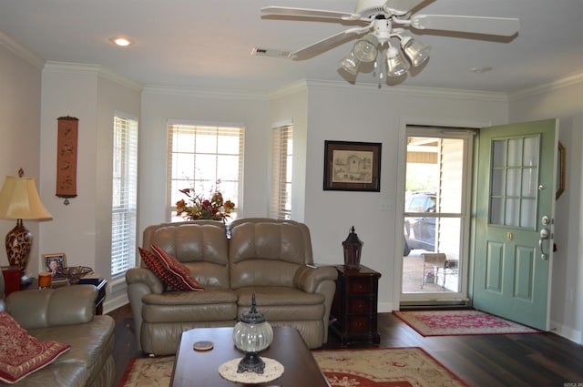 living area with ceiling fan, visible vents, a wealth of natural light, and wood finished floors