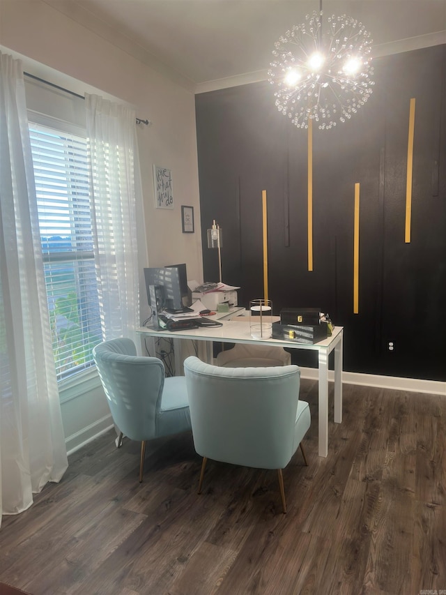 dining space with crown molding, baseboards, a notable chandelier, and wood finished floors