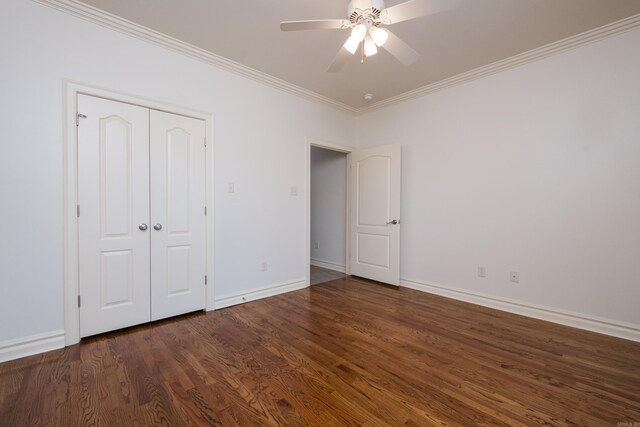 unfurnished bedroom with crown molding, a closet, wood finished floors, baseboards, and a ceiling fan