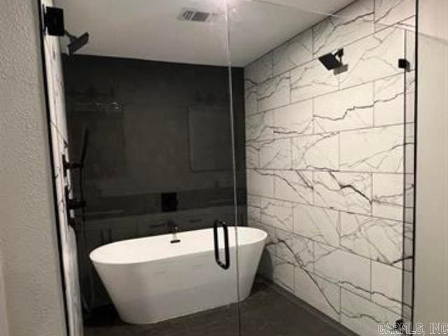 10 Sweetbrush, Texarkana, TX 75503 - full bathroom featuring a freestanding tub, tile walls, and a shower stall