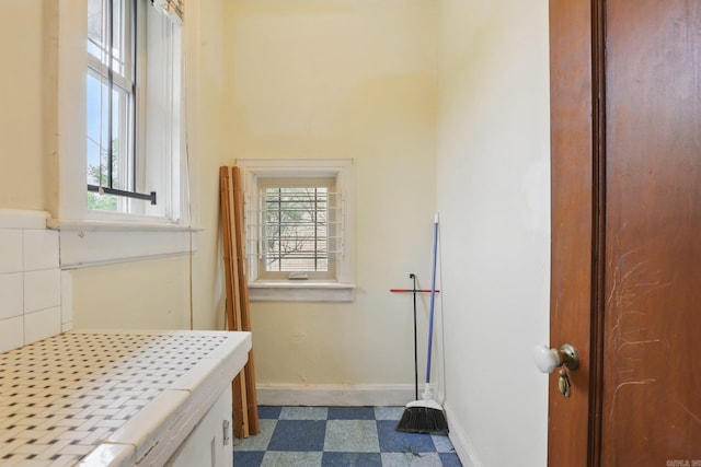 bathroom featuring baseboards and tile patterned floors