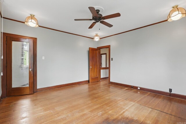 spare room featuring crown molding, a ceiling fan, baseboards, and light wood finished floors