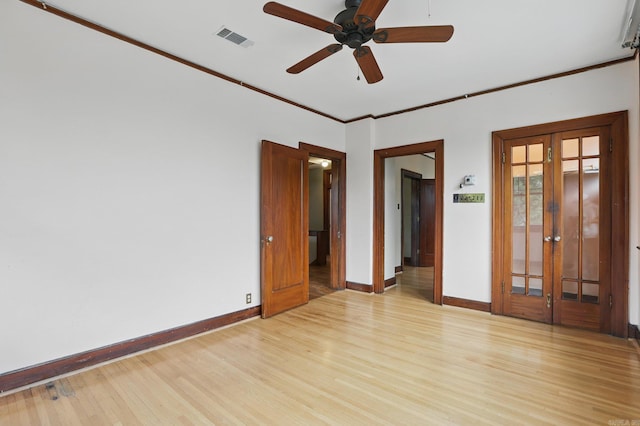 empty room featuring visible vents, french doors, and light wood finished floors