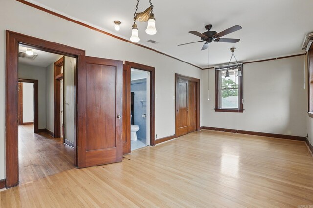 unfurnished bedroom with baseboards, light wood-style flooring, and visible vents