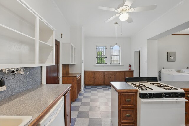 kitchen with brown cabinetry, washer and dryer, white appliances, light floors, and backsplash