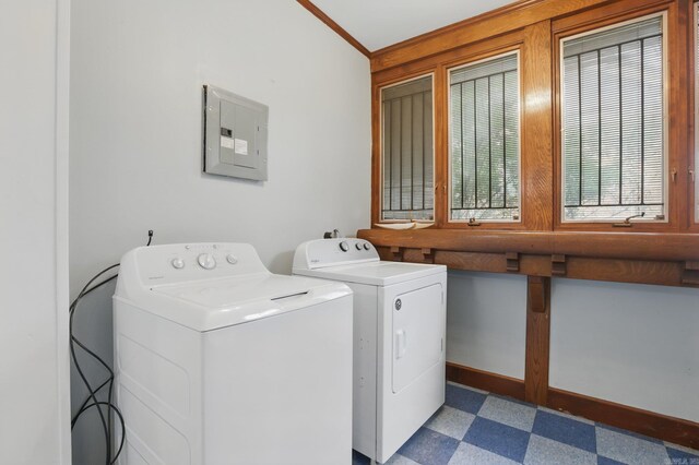 laundry room featuring crown molding, laundry area, tile patterned floors, washing machine and dryer, and electric panel