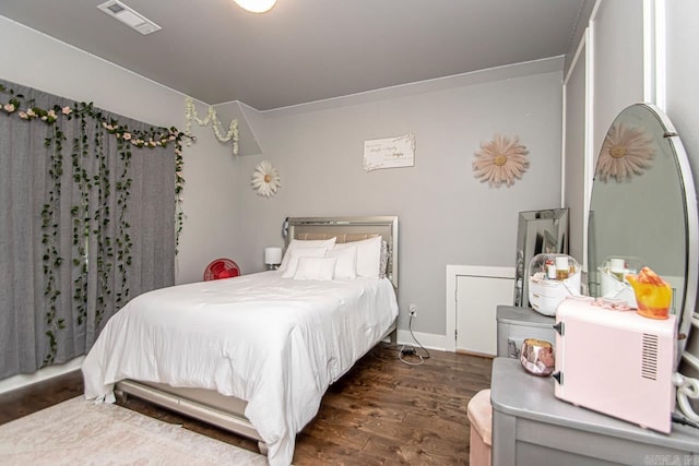 4201 Lovell Ln, Benton, AR 72019 - bedroom featuring baseboards, dark wood-style flooring, and visible vents