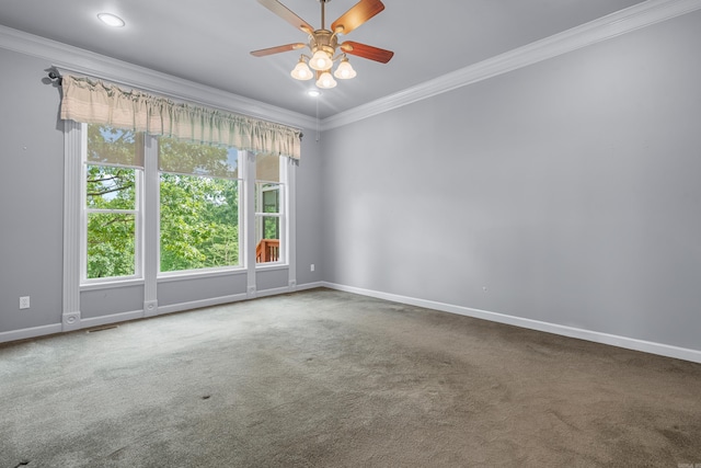 spare room featuring crown molding, carpet, baseboards, and visible vents