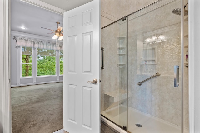full bath with crown molding, ceiling fan, and a stall shower