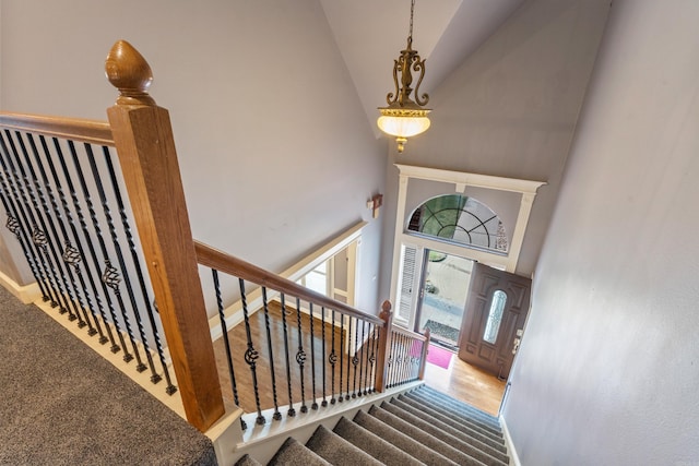 entryway featuring stairway and a towering ceiling