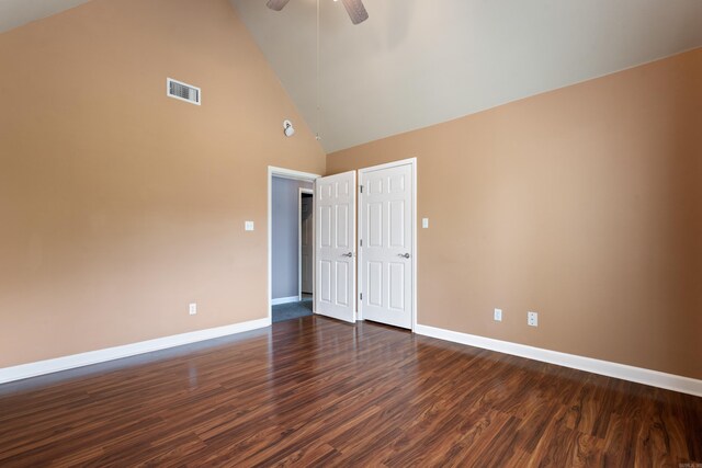 empty room featuring a ceiling fan, baseboards, visible vents, and dark wood-type flooring