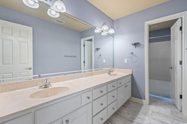 full bath with visible vents, a sink, marble finish floor, and double vanity