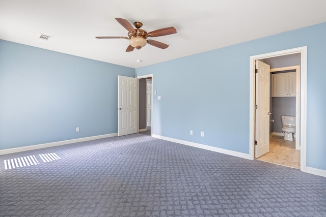 unfurnished bedroom with ceiling fan, visible vents, baseboards, ensuite bathroom, and carpet